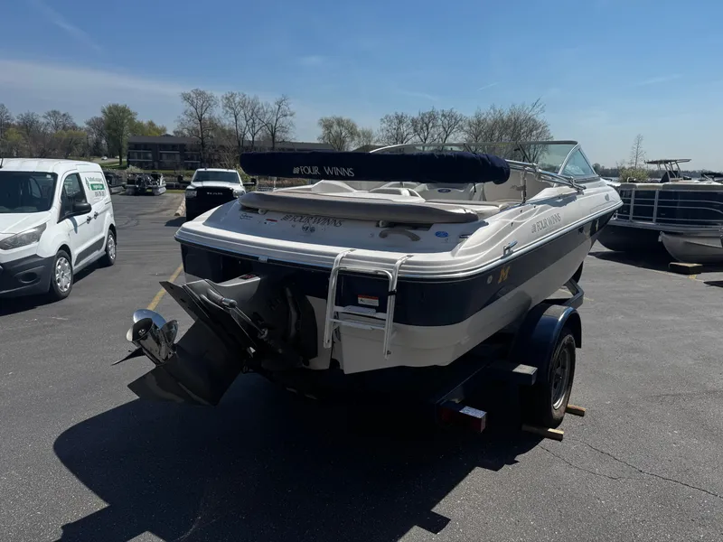 Slide: The Image of 2006 Four Winns 180 Horizon boat on trailer outdoors. - 4