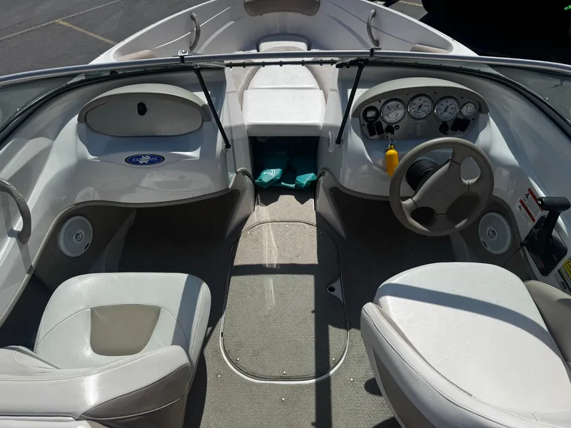 Slide: The Image of Interior of a 2006 Four Winns 180 Horizon boat, showing helm and seating. - 7