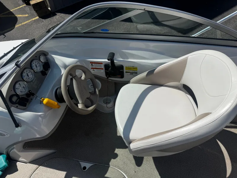 Slide: The Image of Interior of a 2006 Four Winns 180 Horizon boat with steering wheel and seat. - 8