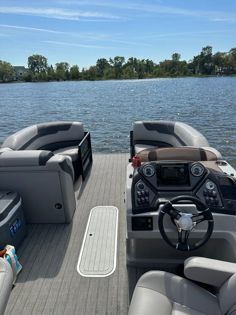 Slide: The Image of Interior view of a 2022 Sylvan L3 CLZ TT pontoon boat on a lake. - 4