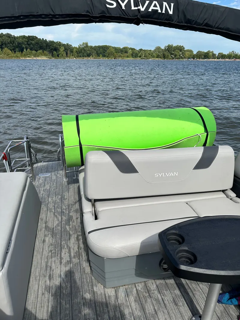Slide: The Image of Sylvan L3 CLZ TT 2022 pontoon boat with green float on lake. - 9