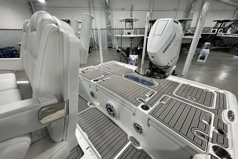 Slide: The Image of 2026 Tidewater 2500 Carolina Bay boat interior with Mercury engine in showroom. - 10