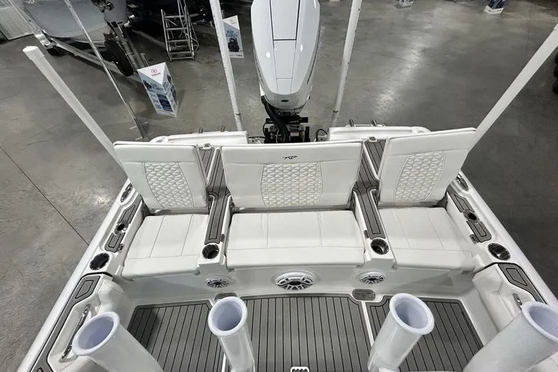 Slide: The Image of 2026 Tidewater 2500 Carolina Bay boat interior with white seating and rod holders. - 14
