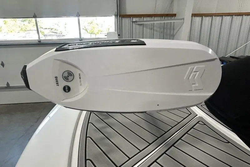 Slide: The Image of 2026 Tidewater 2500 Carolina Bay boat with advanced motor detail in a garage setting. - 15