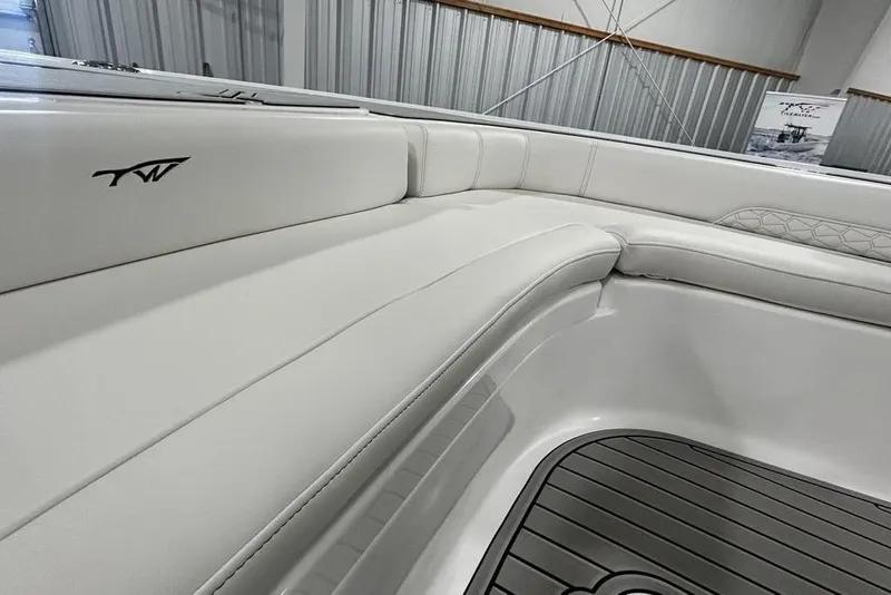 Slide: The Image of 2026 Tidewater 2500 Carolina Bay boat interior with white cushioned seating. - 2
