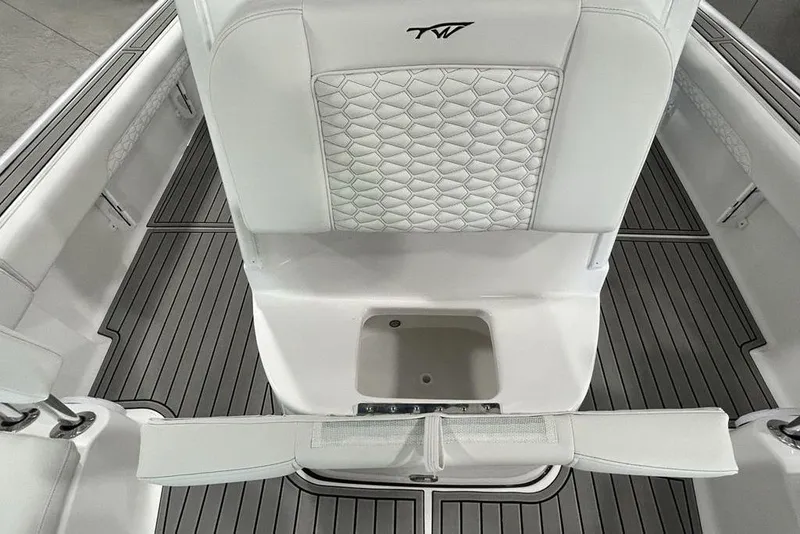 Slide: The Image of 2026 Tidewater 2500 Carolina Bay boat interior with white seating and gray flooring. - 9