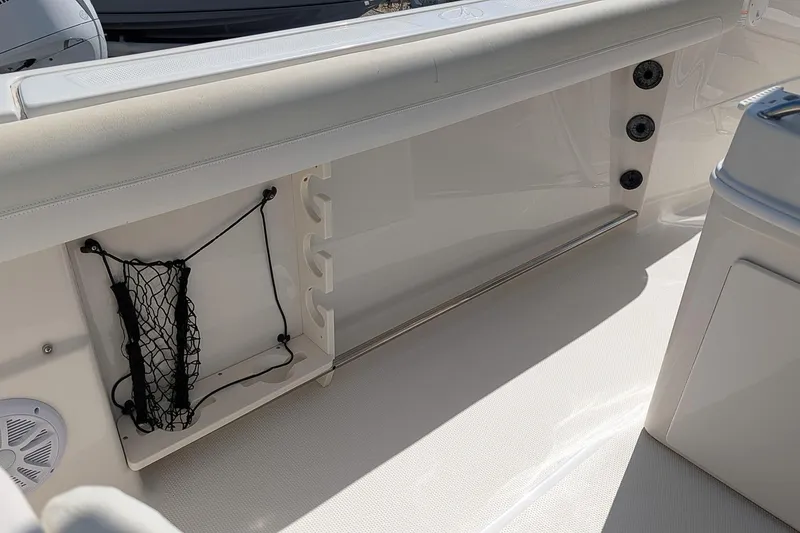 Slide: The Image of Interior view of a 2014 Sailfish 270 CC boat, featuring storage compartments and seating. - 10