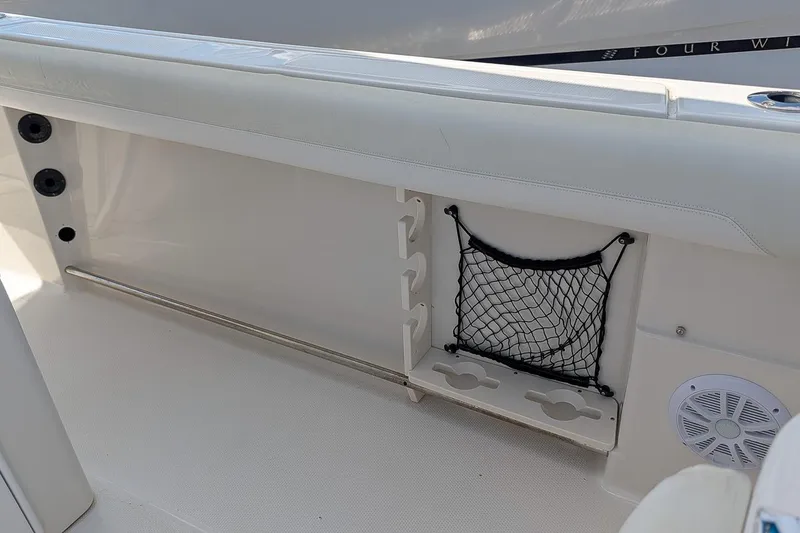 Slide: The Image of Interior view of a 2014 Sailfish 270 CC boat, featuring storage compartments and speaker. - 11