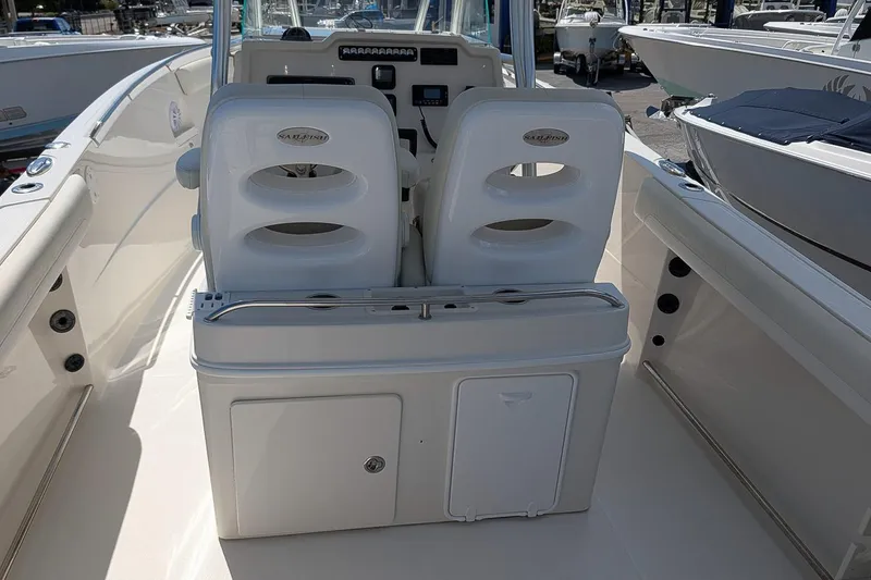 Slide: The Image of 2014 Sailfish 270 CC boat interior with dual seats and storage compartment. - 12