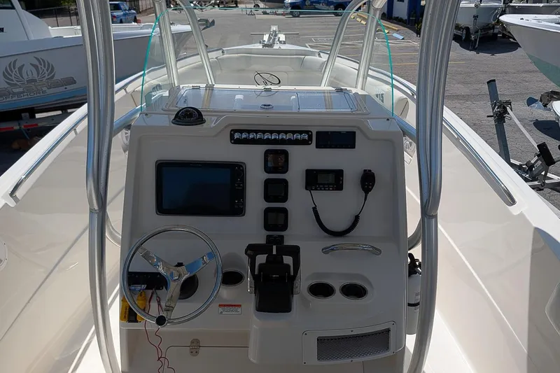 Slide: The Image of 2014 Sailfish 270 CC boat dashboard with steering wheel and navigation controls. - 16