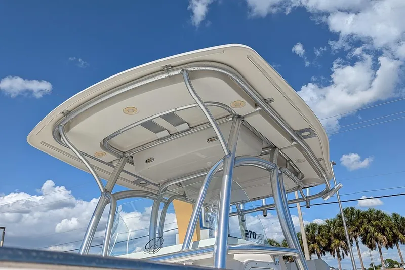 Slide: The Image of 2014 Sailfish 270 CC boat with T-top against a blue sky background. - 24