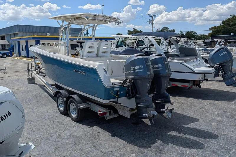 Slide: The Image of 2014 Sailfish 270 CC boat with dual Yamaha engines on a trailer in a marina. - 3