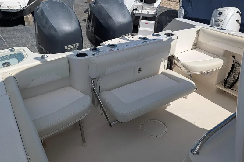 Slide: The Image of 2014 Sailfish 270 CC boat interior with seating and dual Yamaha 150 engines. - 7