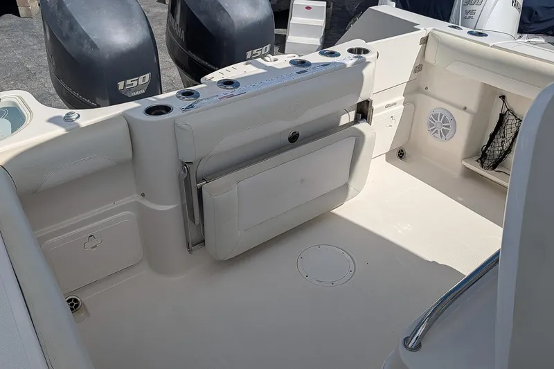 Slide: The Image of 2014 Sailfish 270 CC boat interior with Yamaha 150 engines, featuring seating and storage. - 8