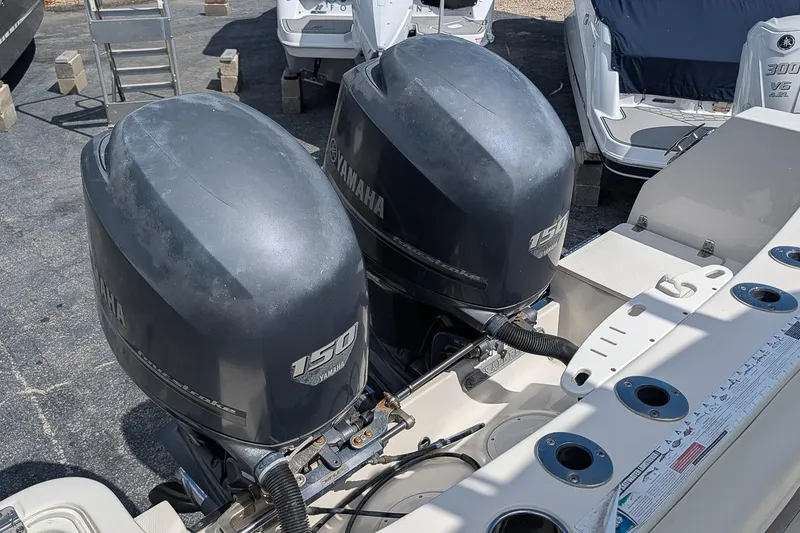 Slide: The Image of Twin Yamaha 150 engines on a 2014 Sailfish 270 CC boat, docked outdoors. - 9