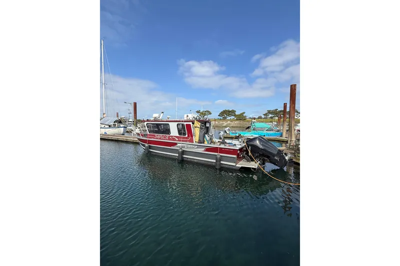 Slide: The Image of 2017 Weldcraft 260 Cuddy King boat docked in a marina under a clear blue sky. - 12