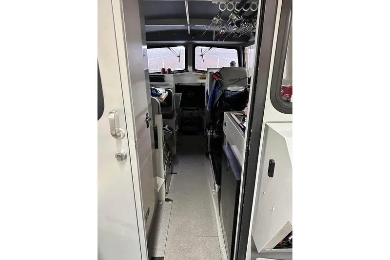 Slide: The Image of Interior view of 2017 Weldcraft 260 Cuddy King boat, showcasing cabin and seating area. - 4