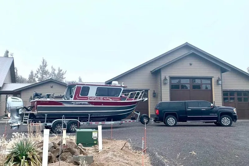 Slide: The Image of 2017 Weldcraft 260 Cuddy King boat on trailer, parked beside a large garage. - 6