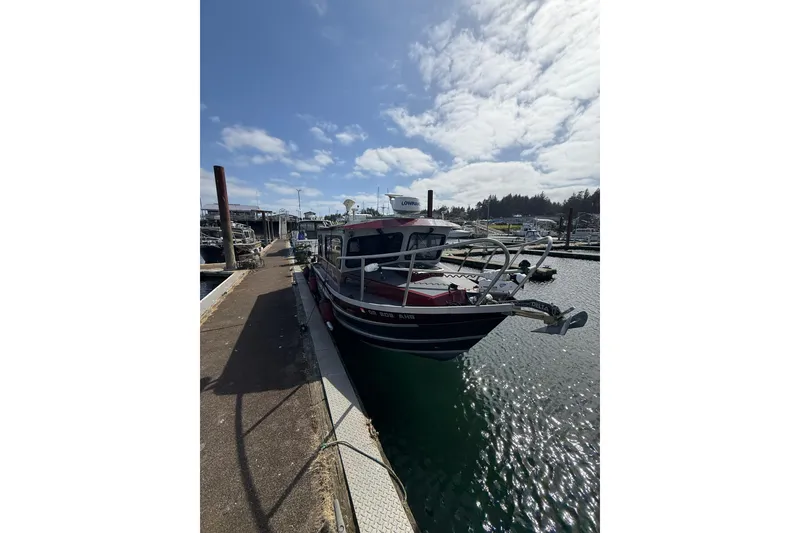 Slide: The Image of 2017 Weldcraft 260 Cuddy King docked at a marina under a partly cloudy sky. - 9