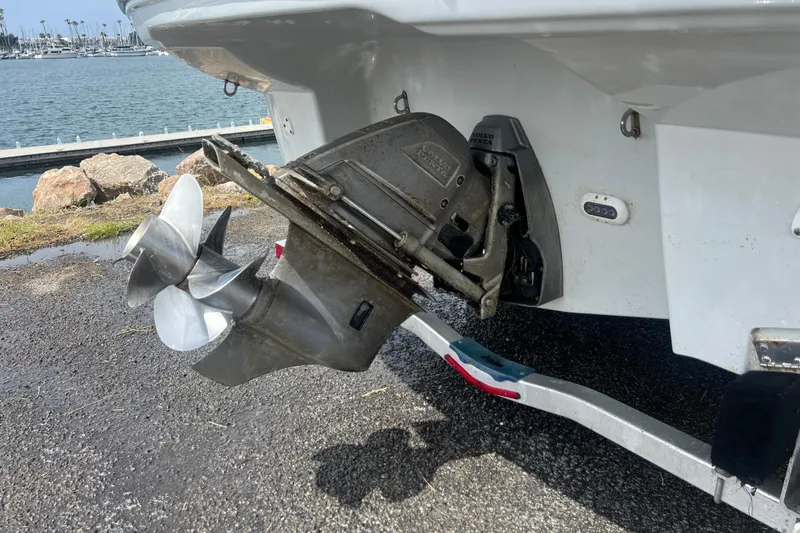 Slide: The Image of 2021 Crownline 264 CR boat propeller and stern drive near waterfront. - 11