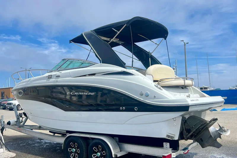 Slide: The Image of 2021 Crownline 264 CR boat on trailer, featuring sleek design and canopy. - 9