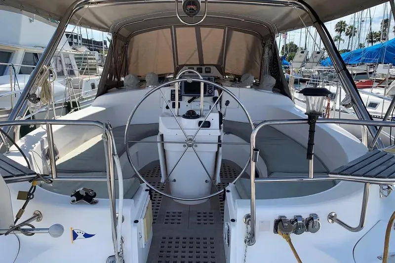 Slide: The Image of Cockpit of a 2000 Hunter 460 sailboat with steering wheel and navigation equipment. - 11