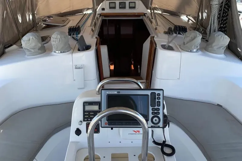 Slide: The Image of Cockpit of a 2000 Hunter 460 sailboat with navigation equipment and seating. - 14