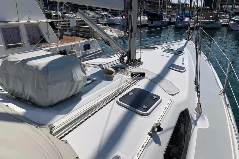 Slide: The Image of Sailboat deck of 2000 Hunter 460 model in marina, featuring clean lines and rigging. - 15
