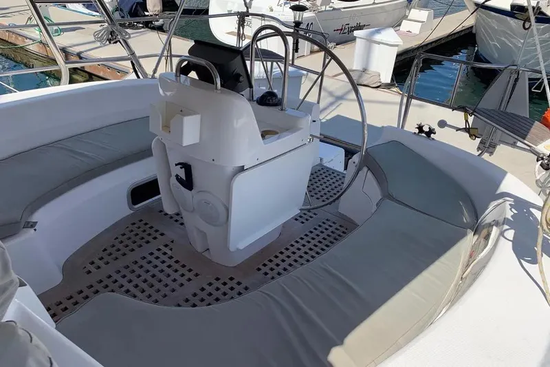 Slide: The Image of Cockpit of a 2000 Hunter 460 sailboat with cushioned seating and steering wheel. - 22