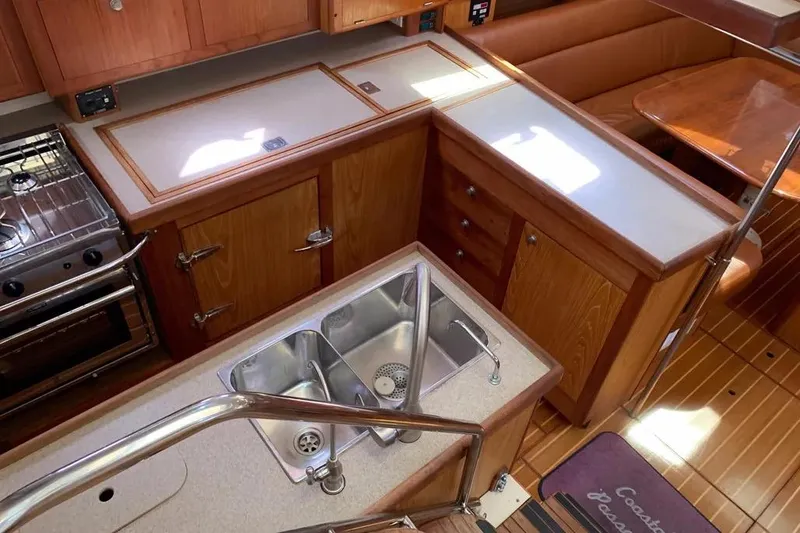Slide: The Image of Modern kitchen interior of 2000 Hunter 460 yacht with wooden cabinetry and stainless steel sink. - 26