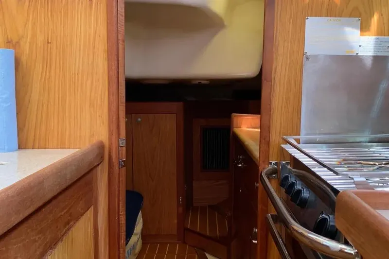 Slide: The Image of Interior of a 2000 Hunter 460 sailboat, featuring a cozy cabin and kitchen area. - 29
