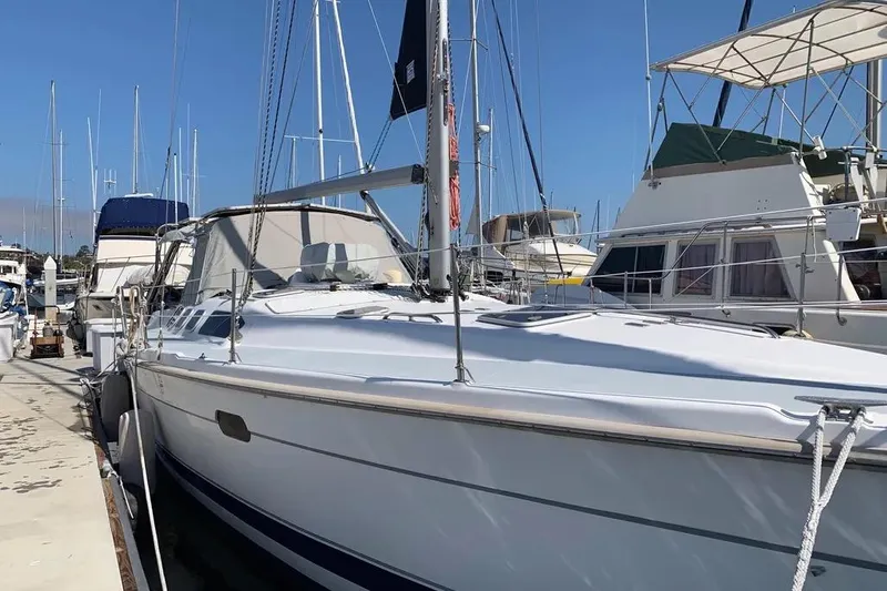 Slide: The Image of Sailboat docked at marina, Hunter 460 model, year 2000, under clear blue sky. - 3