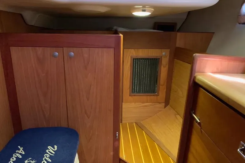 Slide: The Image of Interior cabin of a 2000 Hunter 460 sailboat with wooden cabinetry and seating. - 32