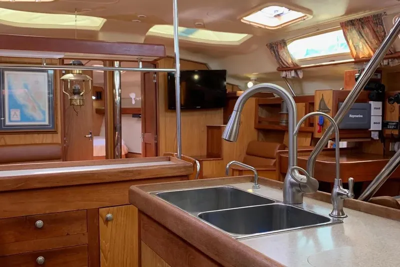 Slide: The Image of Interior of 2000 Hunter 460 yacht with modern kitchen and wooden cabinetry. - 35