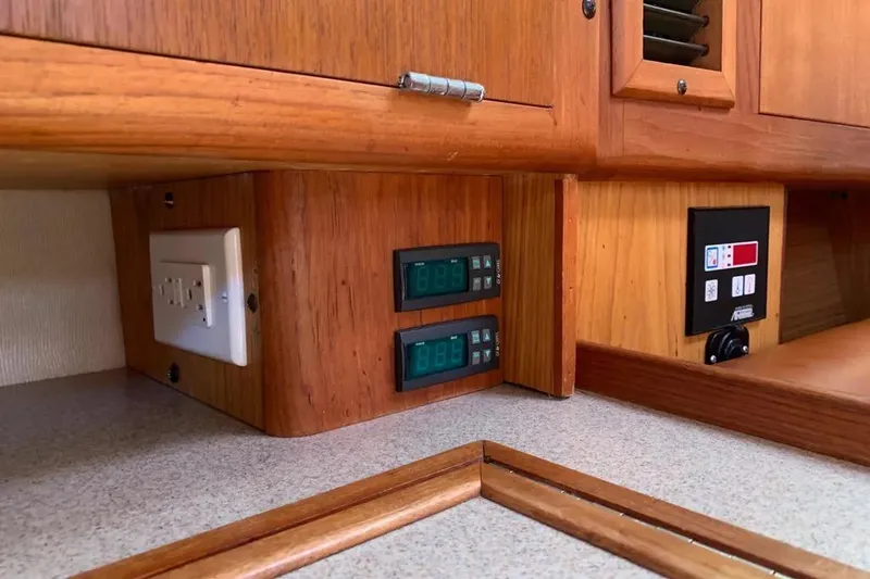 Slide: The Image of Wooden interior of a 2000 Hunter 460 yacht with control panels and outlets. - 37