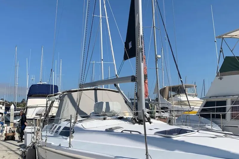 Slide: The Image of 2000 Hunter 460 sailboat docked at marina under clear blue sky. - 4