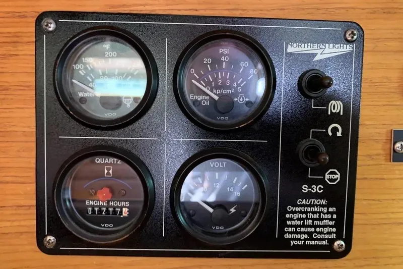 Slide: The Image of Control panel of a 2000 Hunter 460 boat with gauges and switches. - 41