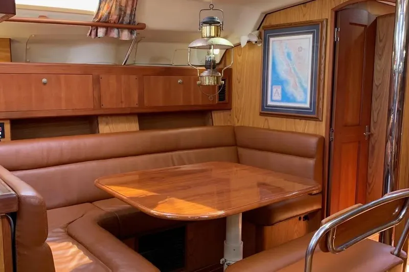 Slide: The Image of Interior of 2000 Hunter 460 yacht with wooden dining area and leather seating. - 43
