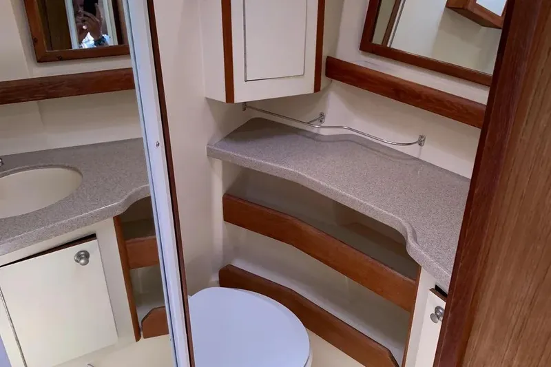 Slide: The Image of Interior of 2000 Hunter 460 yacht bathroom with sink, countertop, and wooden accents. - 48