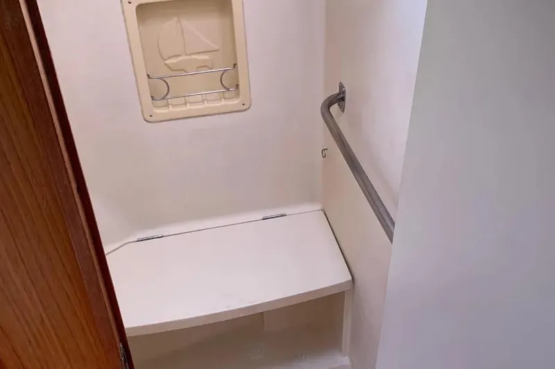 Slide: The Image of Compact bathroom with a foldable seat and grab bar in a 2000 Hunter 460 yacht. - 50