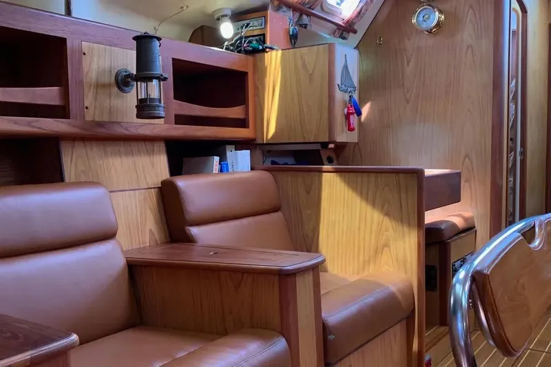 Slide: The Image of Interior of a 2000 Hunter 460 yacht with wooden furnishings and leather seating. - 51
