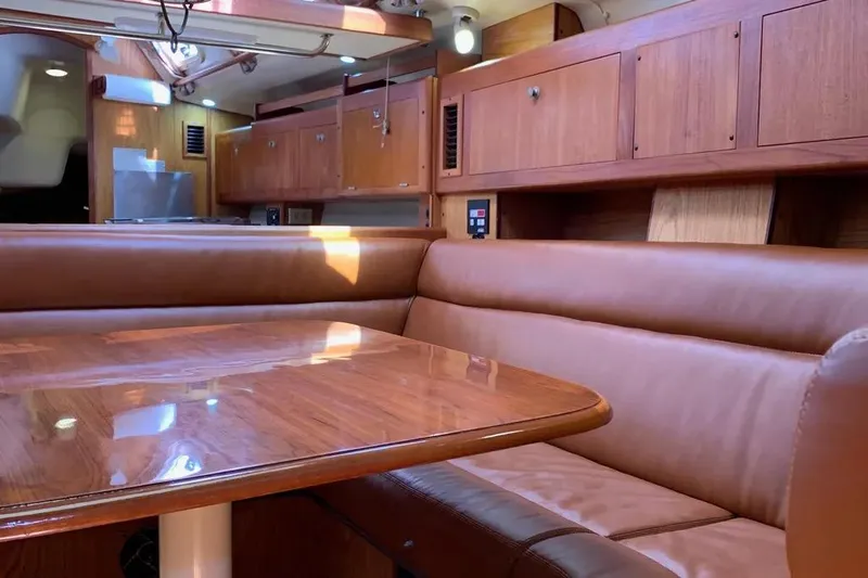 Slide: The Image of Interior of 2000 Hunter 460 yacht with wooden cabinetry and leather seating. - 52