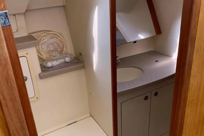 Slide: The Image of Interior of a 2000 Hunter 460 yacht bathroom with sink and storage. - 55