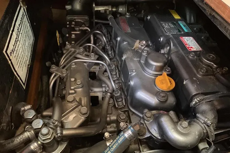 Slide: The Image of Engine compartment of a 2000 Hunter 460 sailboat, showcasing mechanical components. - 60