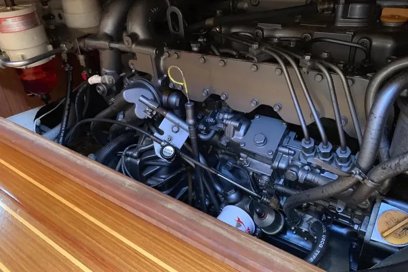 Slide: The Image of Engine compartment of a 2000 Hunter 460 sailboat, showcasing detailed mechanical components. - 61