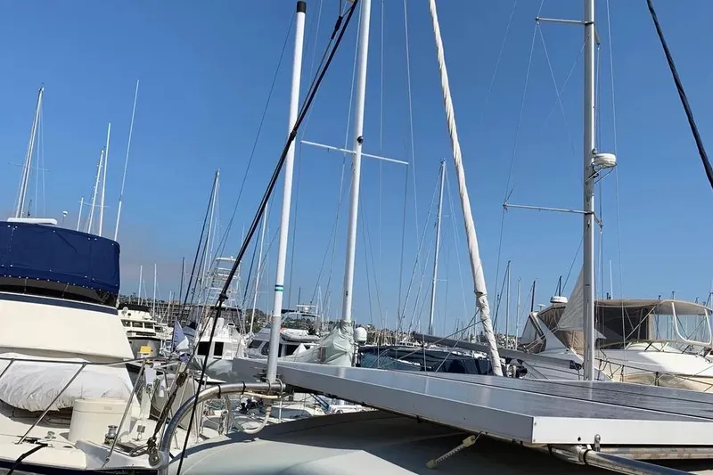 Slide: The Image of Marina with sailboats, featuring a 2000 Hunter 460 yacht under clear blue skies. - 8
