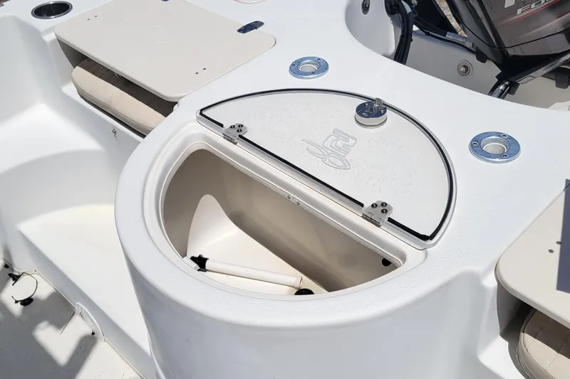 Slide: The Image of 2014 Carolina Skiff 218 DLV boat interior with storage compartment and seating. - 8