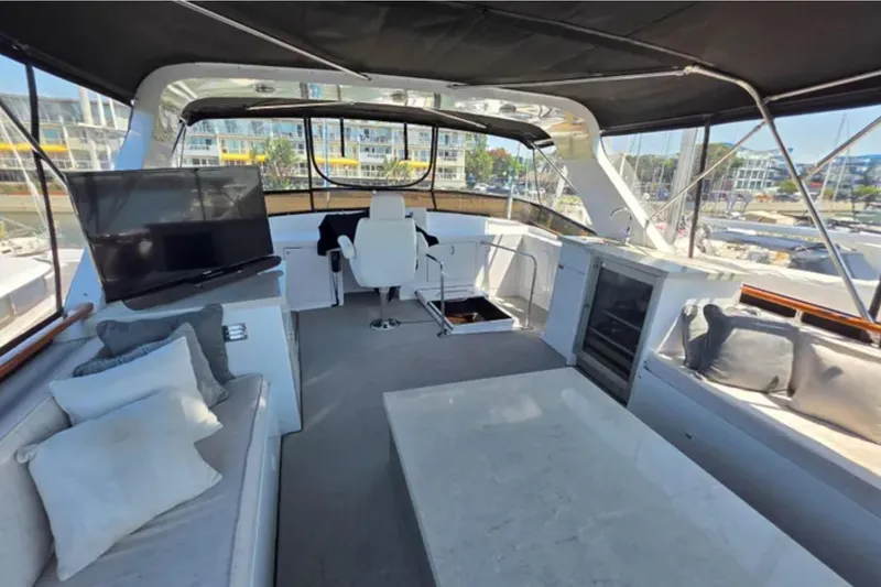 Slide: The Image of 1974 Chris-Craft 68 Roamer Flush Deck interior with seating, TV, and helm station. - 3