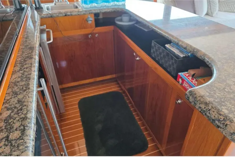 Slide: The Image of 1974 Chris-Craft 68 Roamer Flush Deck kitchen with granite countertops and wooden cabinetry. - 5