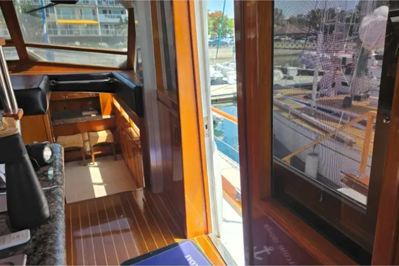 Slide: The Image of Interior view of 1974 Chris-Craft 68 Roamer Flush Deck yacht, showcasing elegant wood finishes. - 6